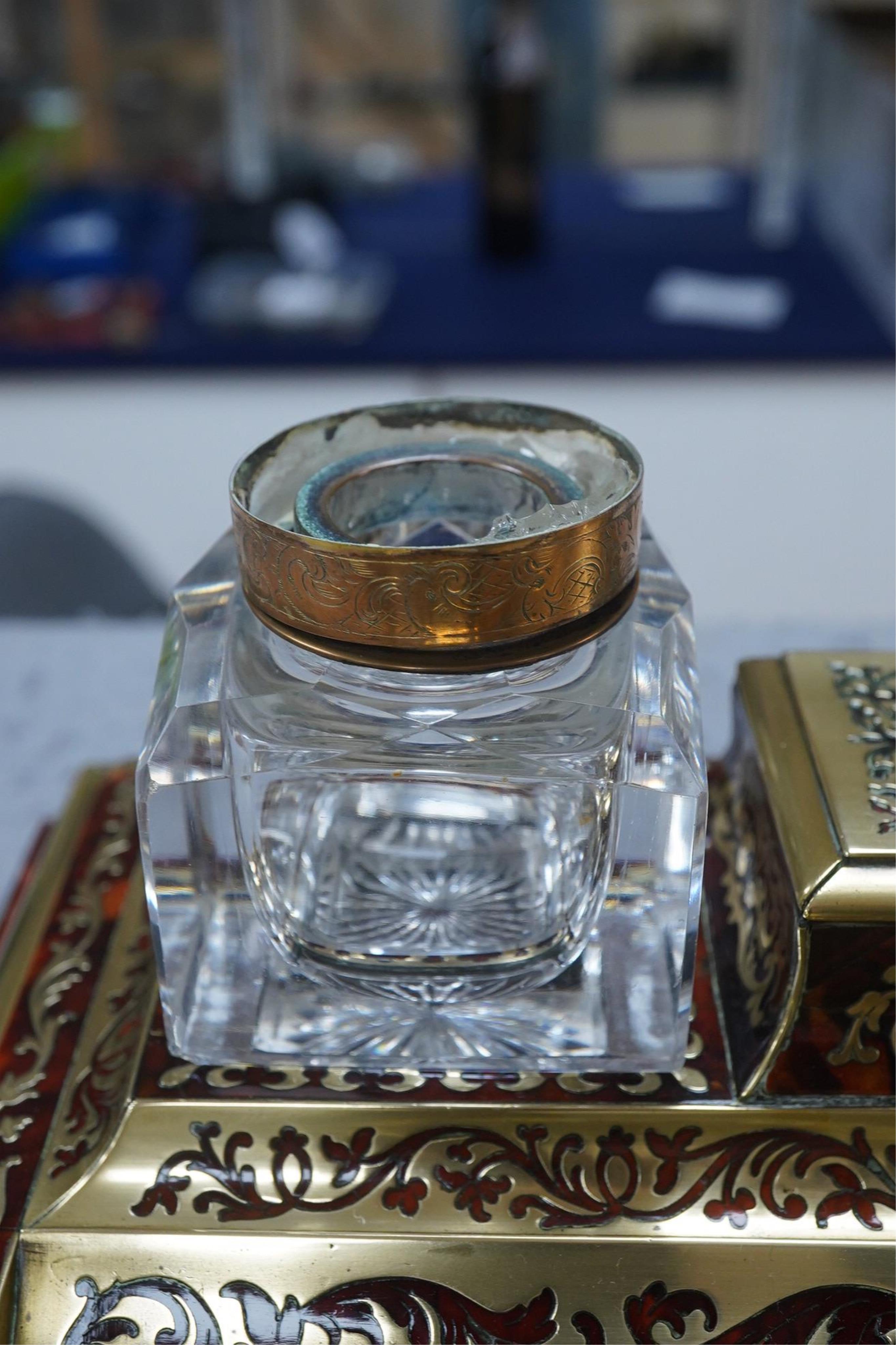 A French scarlet boullework double inkstand with original glass ink bottles c.1850, 39cm wide. Condition - inkstand good, one inkwell cover missing